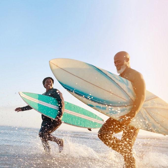 Shot of a mature couple surfing at the beach